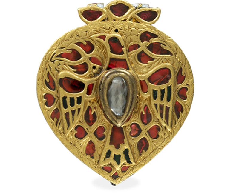 gold pendant inlaid with gemstones
